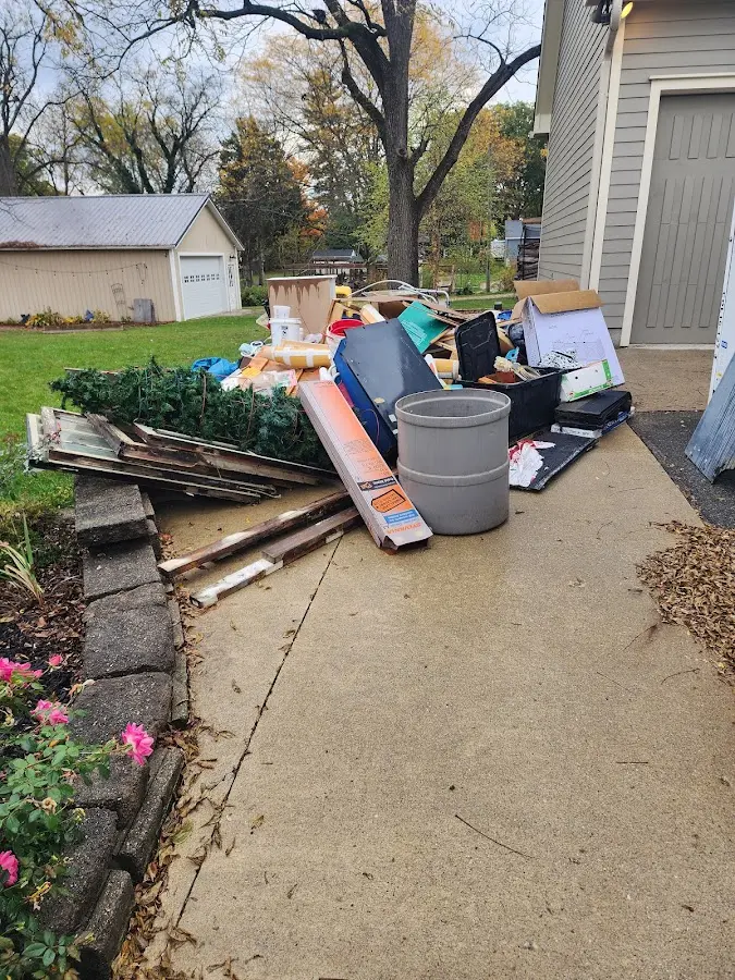 Dumpster being loaded with debris for Commercial Dumpster Rental in Tishomingo